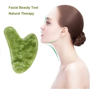 Green heart-shaped wholesale jade gua sha tool for B2B private label beauty brands.