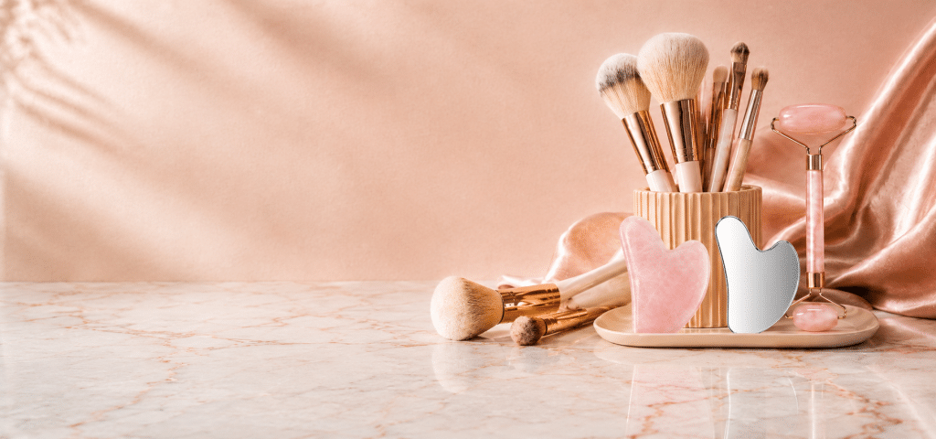 Customized private label makeup brushes, natural stone rose quartz rollers, and metal gua sha scrapers for wholesale.